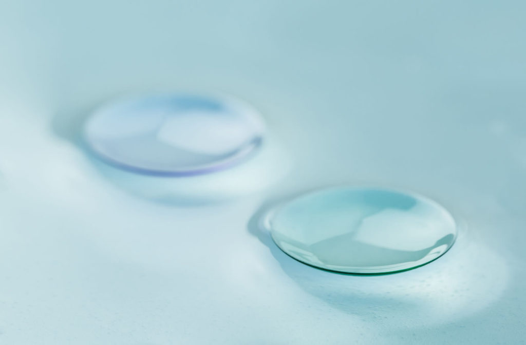 A close-up of modern rigid gas permeable contact lenses for astigmatism.
